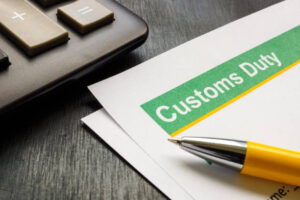 Customs duty document with pen — reviewing import duty costs